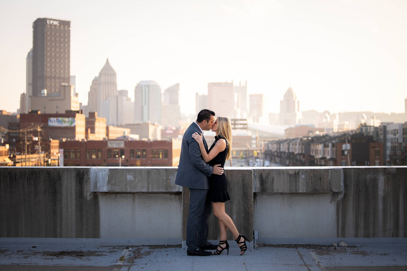 Henne Engagement Ring Couple Brandon & Sarah Kiss While Overlooking The City