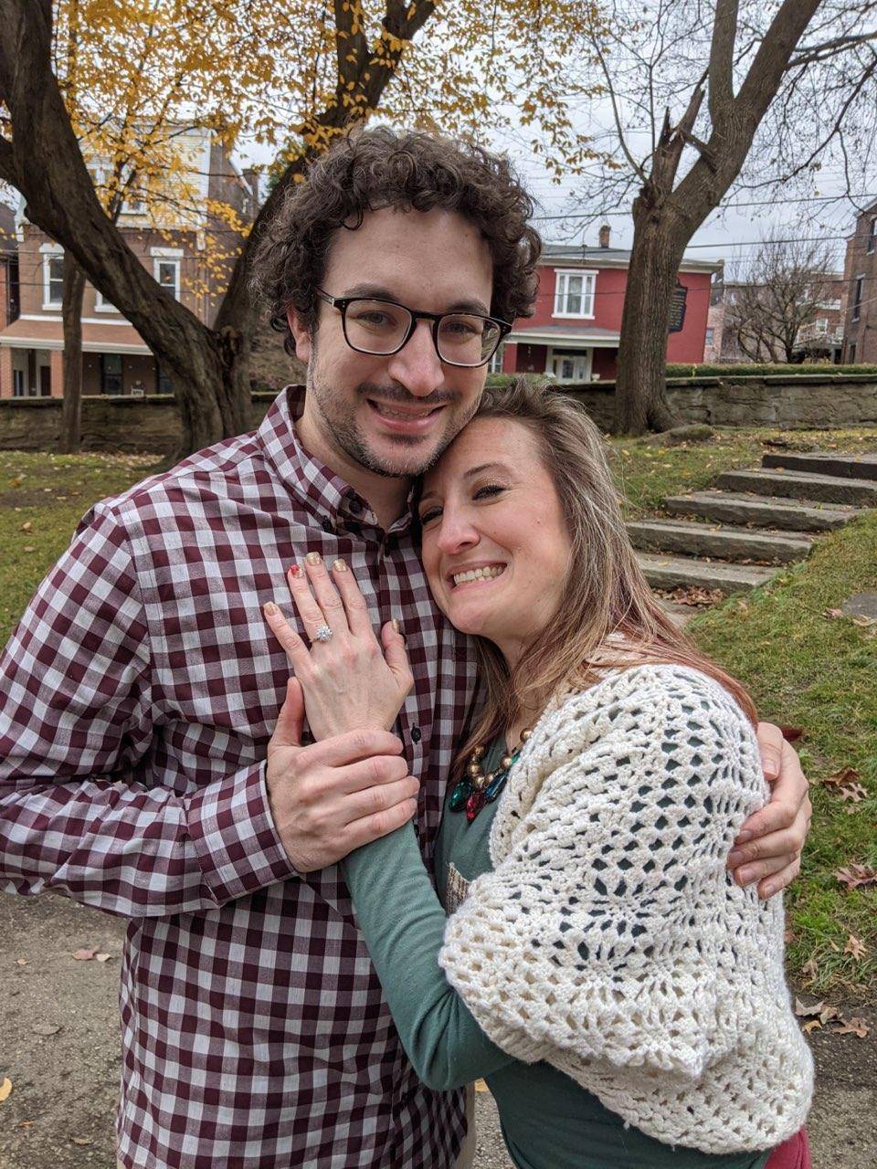 Henne Engagement Ring Couple Aric & Caroline Hugging Outdoors