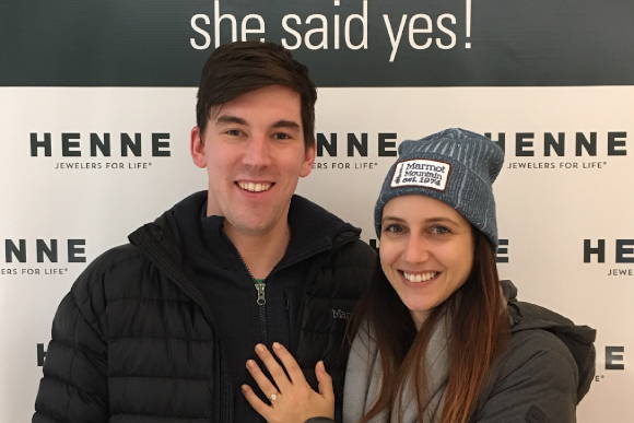 Kevin and Danielle Standing in Front of Henne's "She Said Yes!" Sign