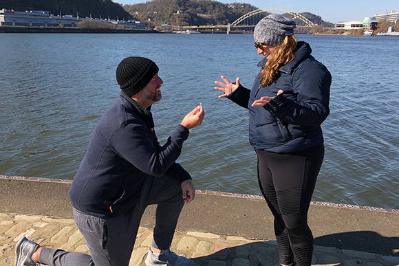 Andrew Proposes to Mia With a Henne Engagement Ring While Standing Next to the River 