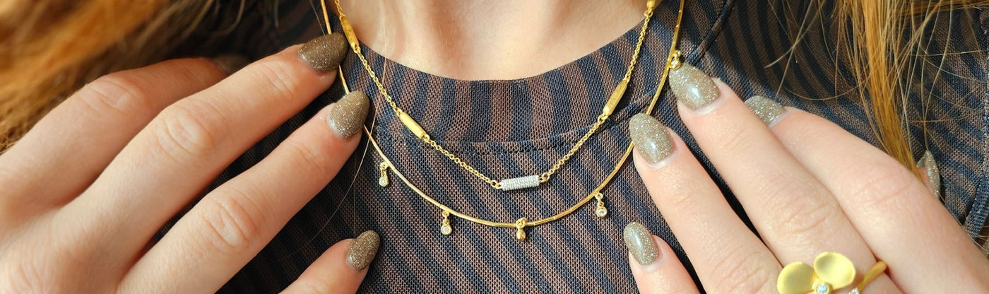 layered Marika necklaces on a woman