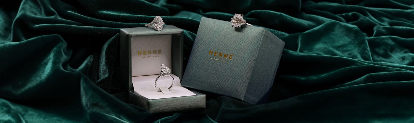 three-stone diamond engagement ring on snowy tree
