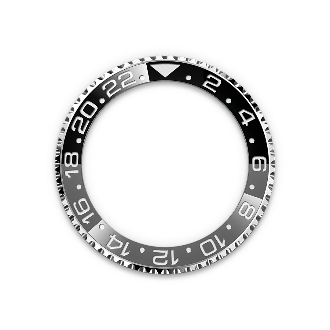 Black and silver watch bezel with 24-hour markings and a triangular indicator at the top, designed for a luxury timepiece with a rugged, polished finish.