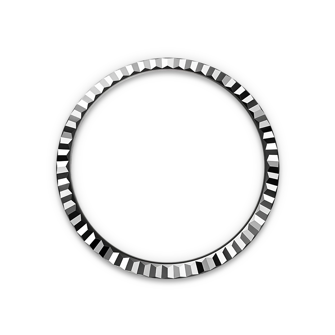 Silver bezel ring with a faceted, geometric edge design on a black background, highlighting luxury craftsmanship and fine jewelry detail.