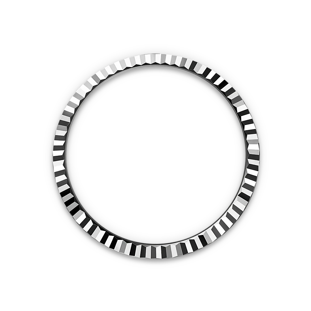 Close-up of a polished silver bezel ring with faceted edges displayed against a black background, highlighting fine craftsmanship and elegance.