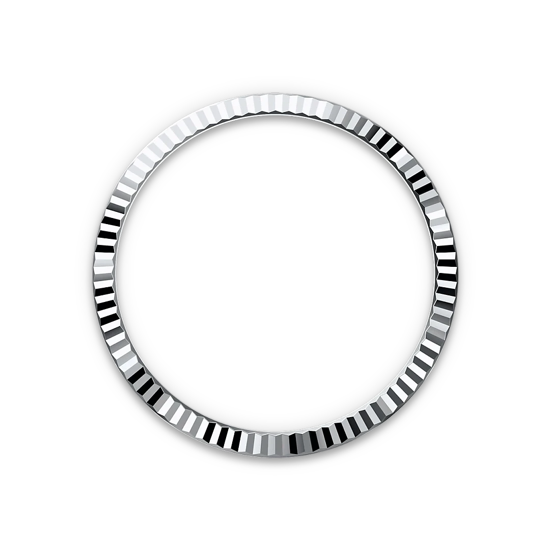 Close-up of a polished silver bezel ring with alternating reflective facets, set against a black background, representing fine craftsmanship in luxury jewelry.
