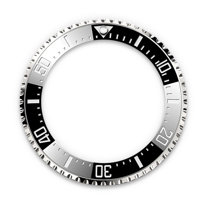 Silver and black bezel ring for a luxury watch, featuring minute markers and a luminous triangle at the 12 o’clock position, designed for a Rolex timepiece.