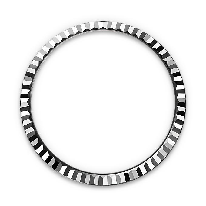 Circular metallic bezel with evenly spaced faceted edges, displayed against a black background, showcasing precise craftsmanship and luxury watch design.