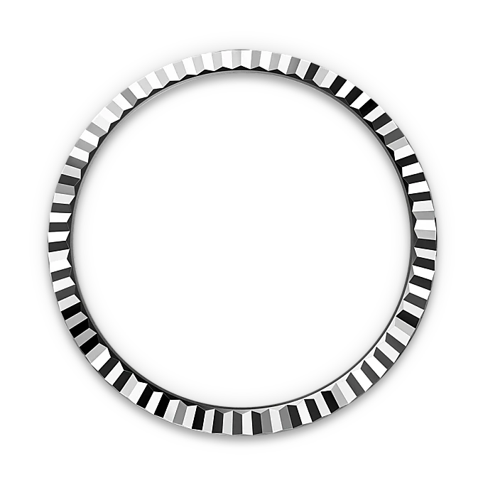 Close-up of a polished, silver-toned bezel ring with a faceted, geometric design on a black background, showcasing fine craftsmanship and luxury detail.