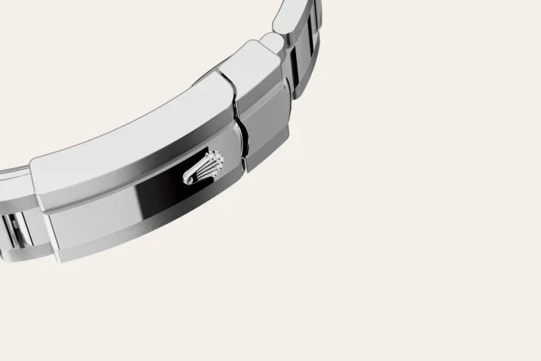 Close-up of a silver-tone metal watch clasp featuring the iconic Rolex crown logo, highlighting fine craftsmanship from a luxury jeweler known for exceptional customer service.