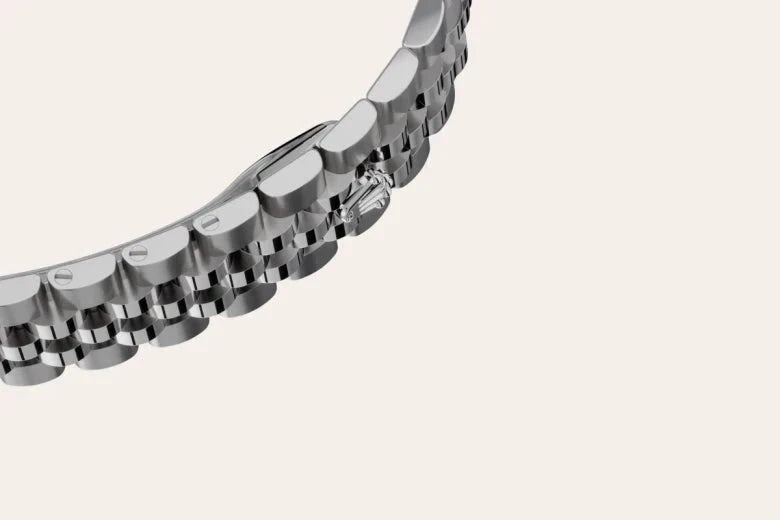 Close-up of a sleek silver watch bracelet with polished and brushed metal links, highlighting the fine craftsmanship of luxury jewelry by a family-owned jeweler.