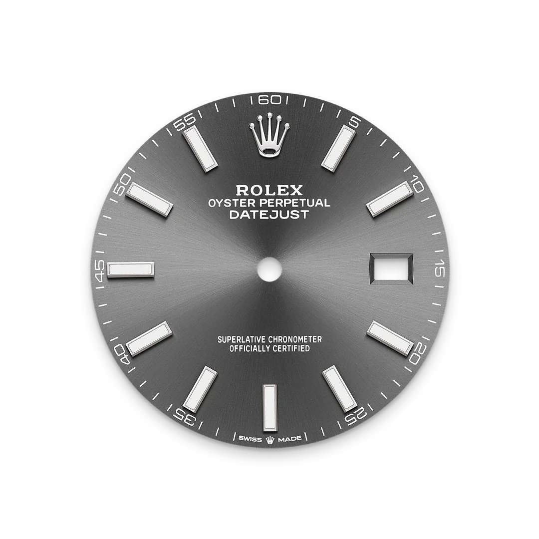 Close-up of a grey Rolex Oyster Perpetual Datejust watch dial featuring silver hour markers, the Rolex crown logo at 12 o’clock, and a date window at 3 o’clock, emphasizing luxury watch craftsmanship.