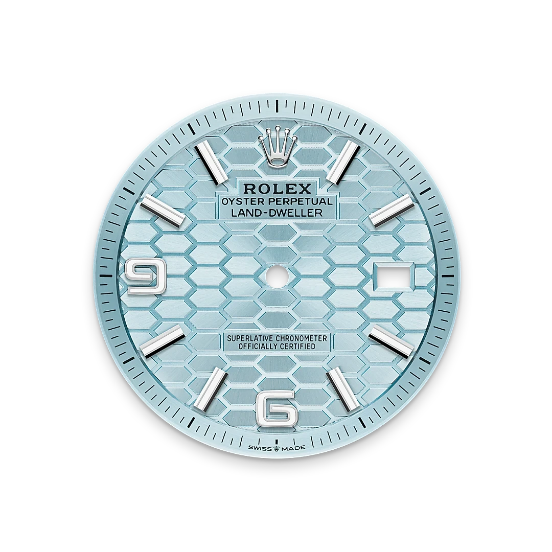 Close-up of a light blue Rolex Oyster Perpetual Land-Dweller watch face with silver hour markers, a textured hexagonal pattern, and a date window, showcasing luxury craftsmanship.