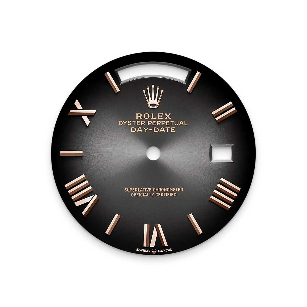 Close-up of a black Rolex Oyster Perpetual Day-Date watch dial featuring rose gold Roman numeral hour markers and a date window, showcasing luxury watch craftsmanship.