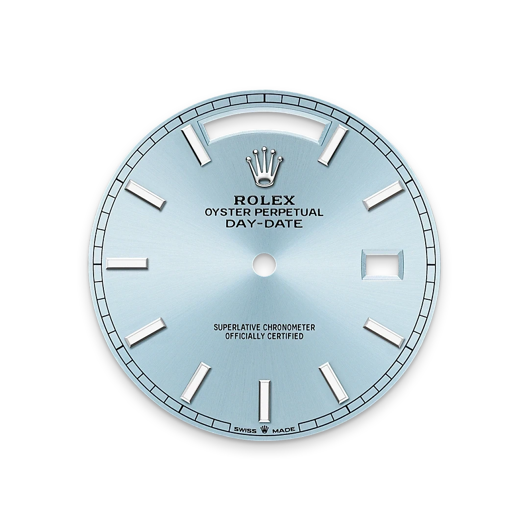 Rolex Oyster Perpetual Day-Date watch dial in light blue with silver hour markers, featuring the Rolex crown logo and certification text, representing luxury watch craftsmanship.