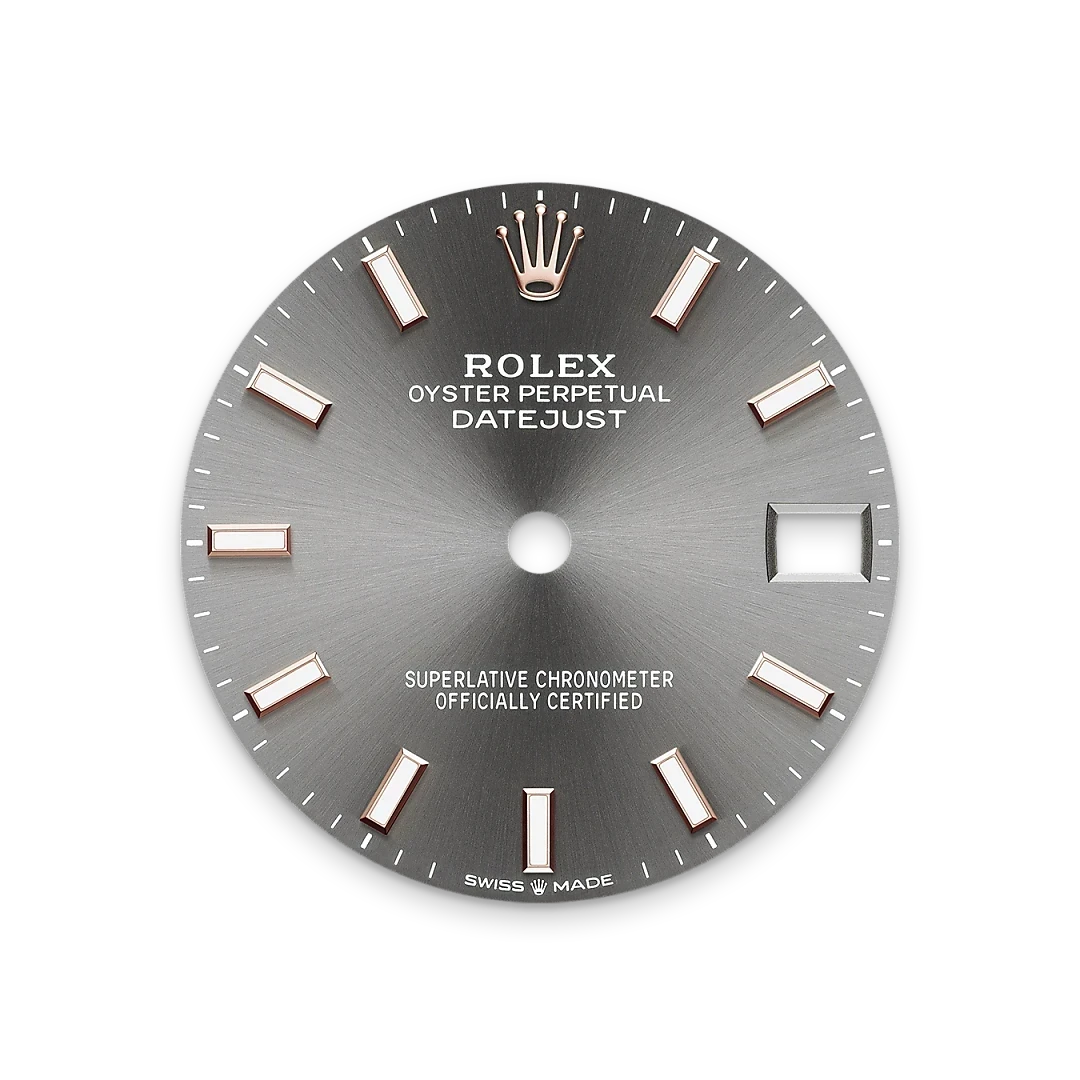 Close-up of a silver Rolex Datejust watch dial with rose gold hour markers, the Rolex crown logo at 12 o'clock, and a date window at 3 o'clock, highlighting fine luxury watch craftsmanship.