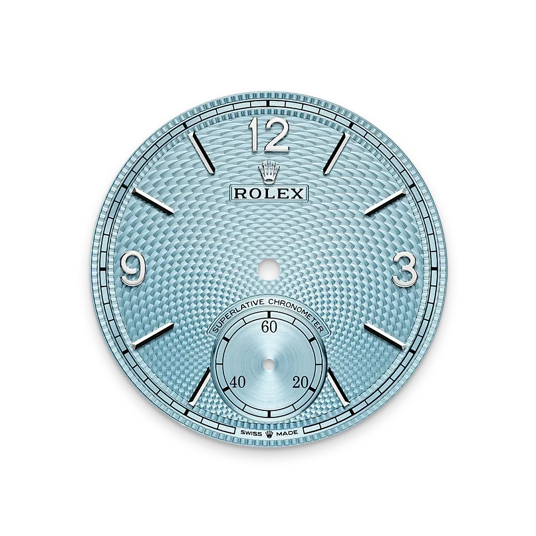 Close-up of a textured light blue Rolex watch dial featuring silver hour markers, the Rolex crown logo, and a small seconds subdial, showcasing luxury watch craftsmanship.