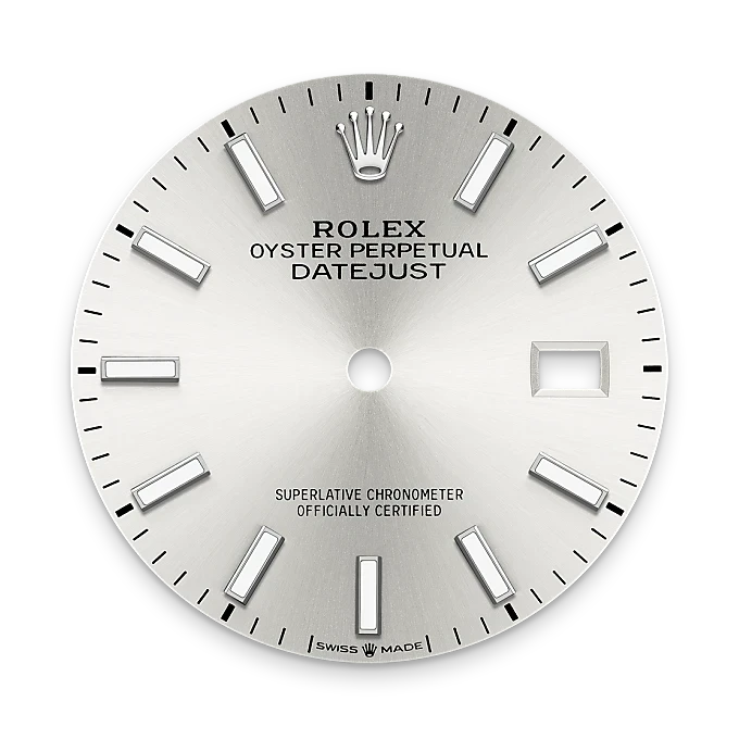 Close-up of a silver Rolex Oyster Perpetual Datejust watch dial displaying hour markers, the Rolex crown logo, and a date window on a black background.