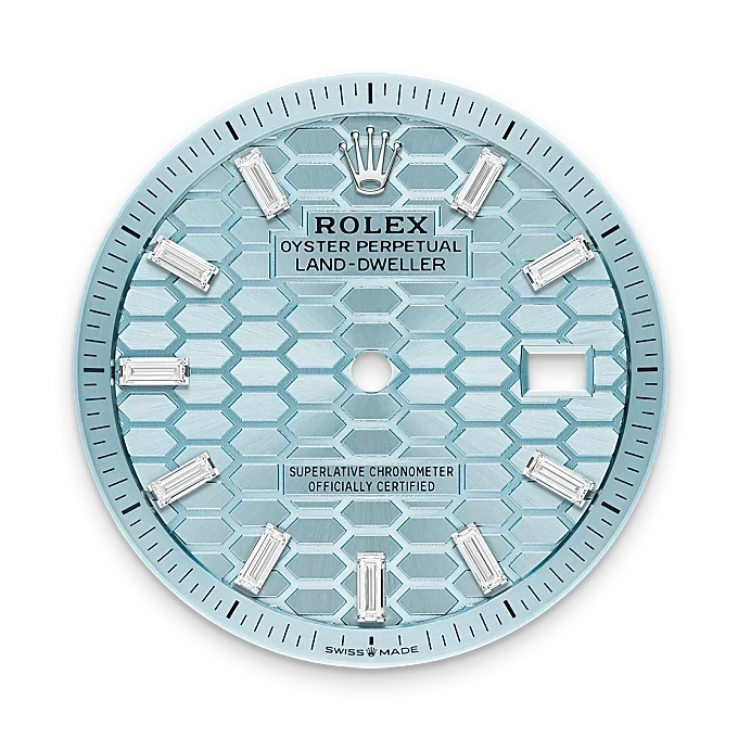 Close-up of a light blue Rolex Oyster Perpetual Land-Dweller watch dial featuring baguette diamond hour markers, the Rolex crown logo at 12 o'clock, and a date window at 3 o'clock.