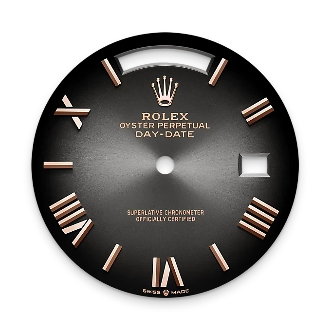 Close-up of a sleek dark watch dial with rose gold Roman numeral hour markers, signature Rolex crown logo, and inscriptions indicating Oyster Perpetual Day-Date and official chronometer certification.