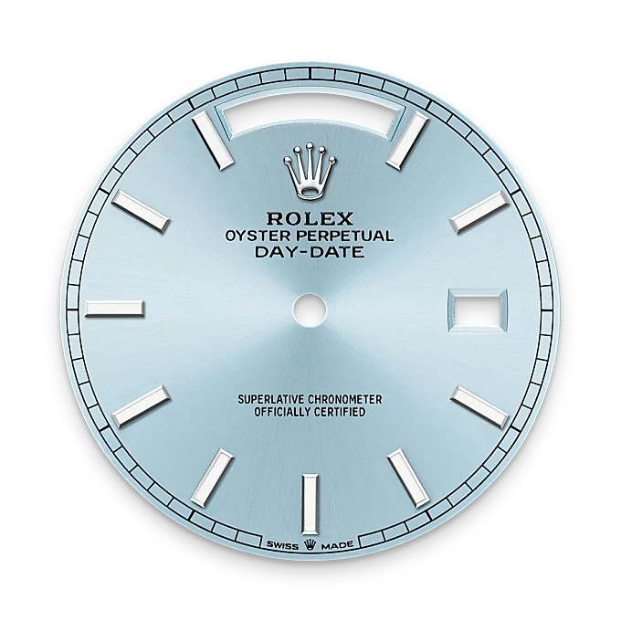 Close-up of a light blue Rolex Oyster Perpetual Day-Date watch dial featuring silver hour markers, the Rolex crown logo, and text indicating its superlative chronometer certification, against a black background.