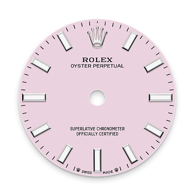 Close-up of a pink Rolex Oyster Perpetual watch dial featuring silver hour markers and the Rolex crown logo, highlighting luxury watch craftsmanship.