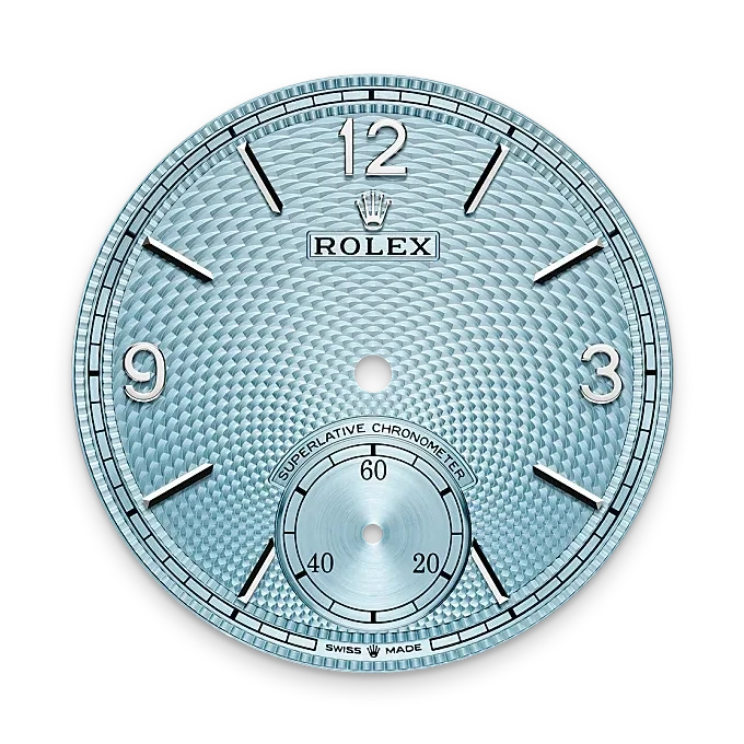 Close-up of a light blue Rolex watch dial with silver hour markers, the Rolex crown logo, and a small seconds subdial at the 6 o'clock position, showcasing fine luxury watch craftsmanship.