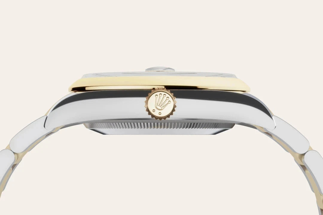 Side close-up view of a luxury two-tone wristwatch featuring a gold crown with the Rolex logo, polished stainless steel case, and a metal link bracelet.