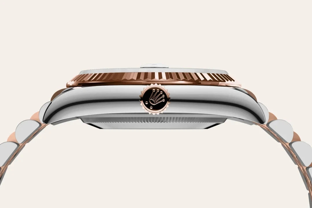 Side profile of a luxury two-tone Rolex watch featuring a silver and rose gold bracelet with a fluted bezel and the Rolex crown logo on the winding crown.