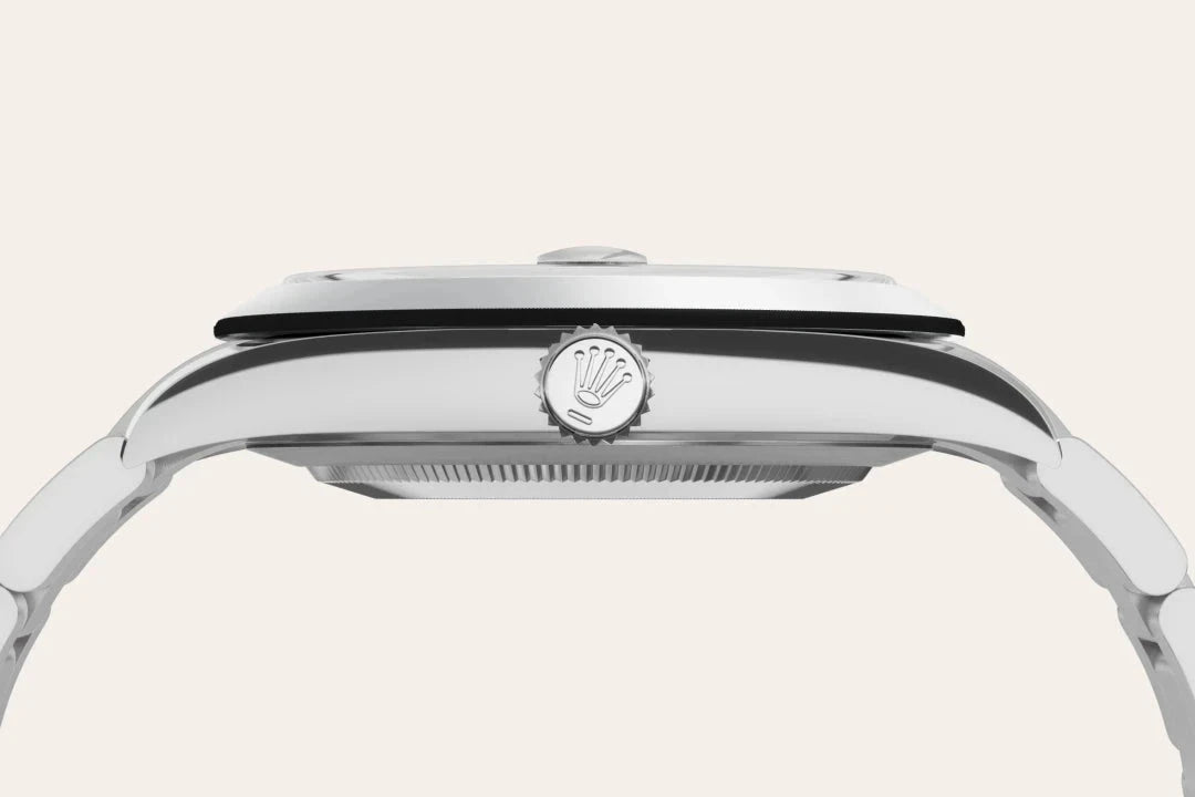 Close-up side view of a polished luxury watch case focusing on the winding crown featuring the iconic Rolex logo, highlighting craftsmanship and design quality.