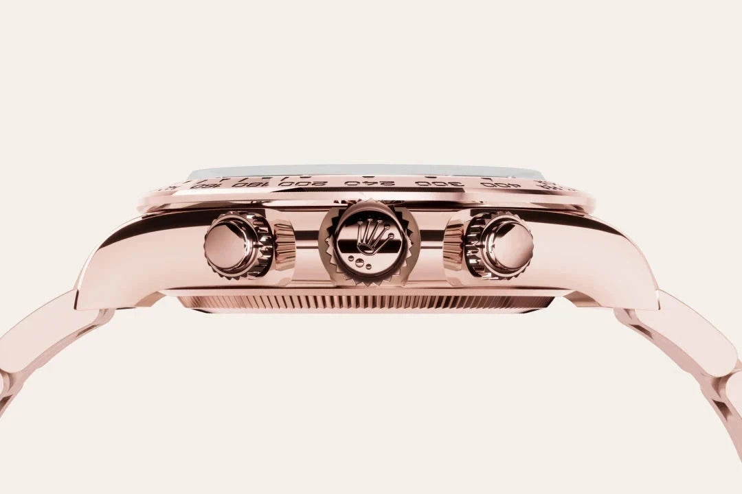 Close-up side profile of a luxury rose gold watch featuring detailed crown and pushers, showcasing fine craftsmanship and elegant design.