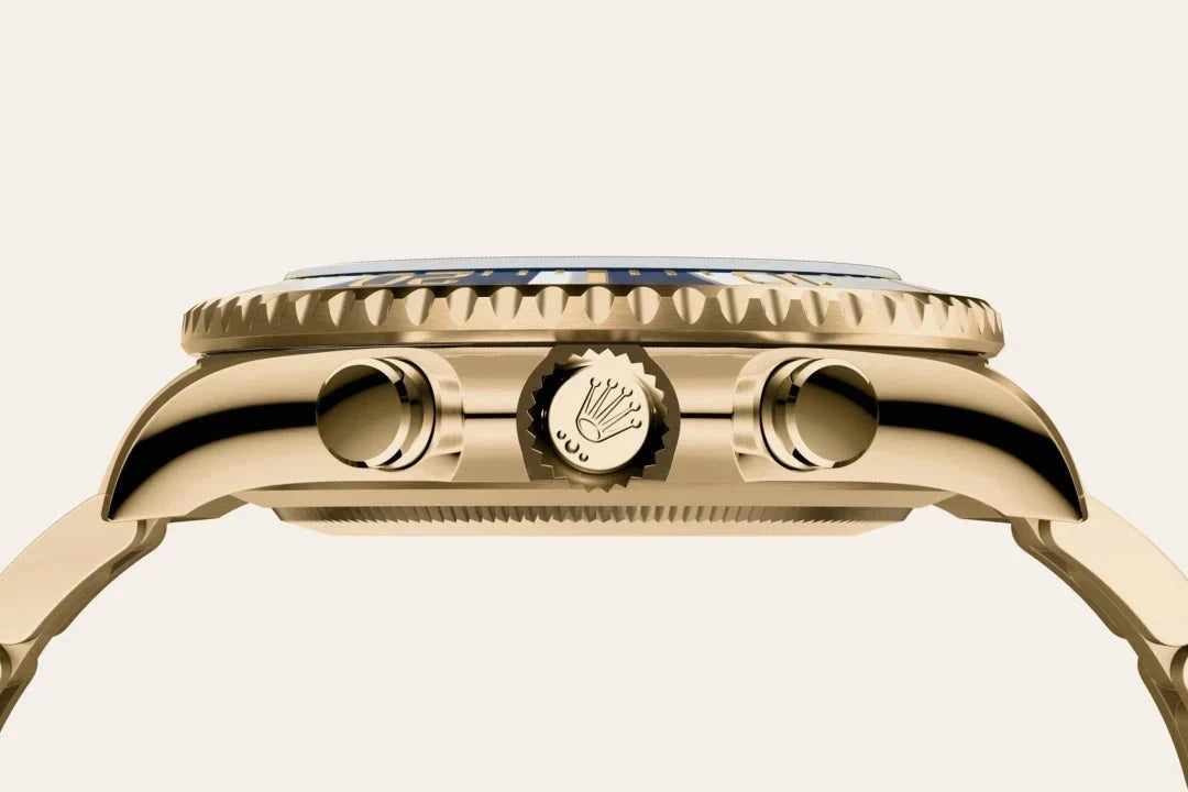 Close-up side view of a luxury gold watch case featuring the Rolex crown logo on the winding crown, showcasing fine craftsmanship and polished detailing.