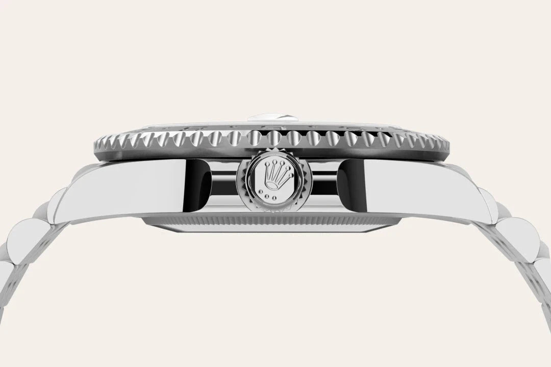 Side view close-up of a polished stainless steel Rolex watch case and crown showcasing fine craftsmanship and luxury watch design.