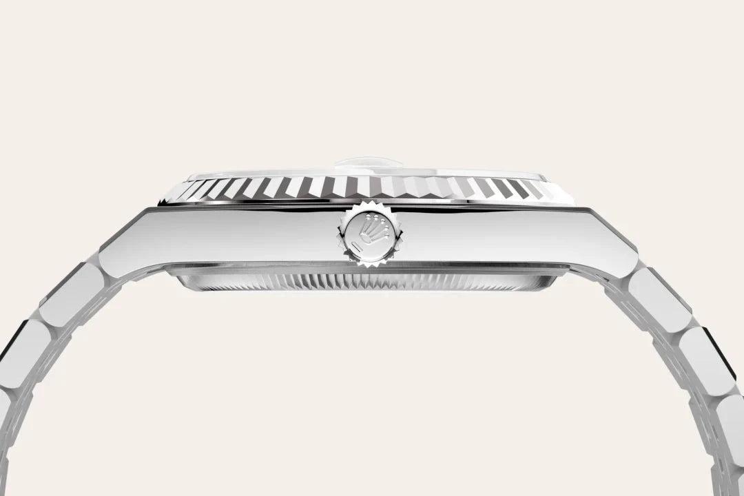 Side profile of a luxury stainless steel watch featuring a detailed bezel and crown with a polished finish, highlighting precision craftsmanship.