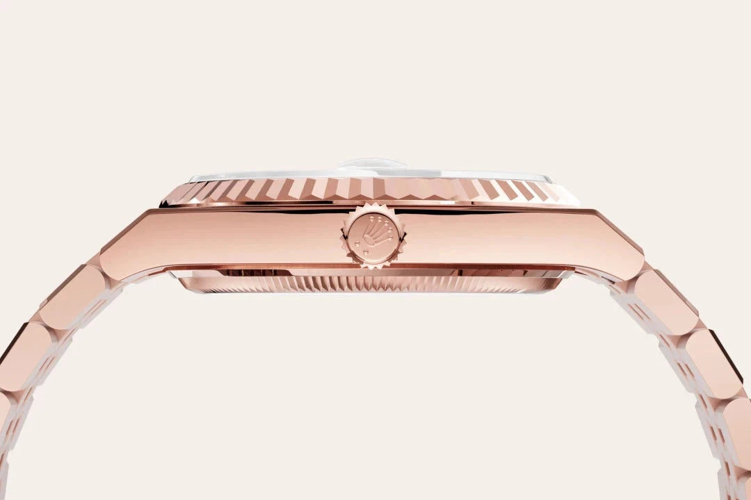 Side view of a rose gold luxury watch with a fluted bezel and a linked bracelet, showcasing craftsmanship and elegant design details.