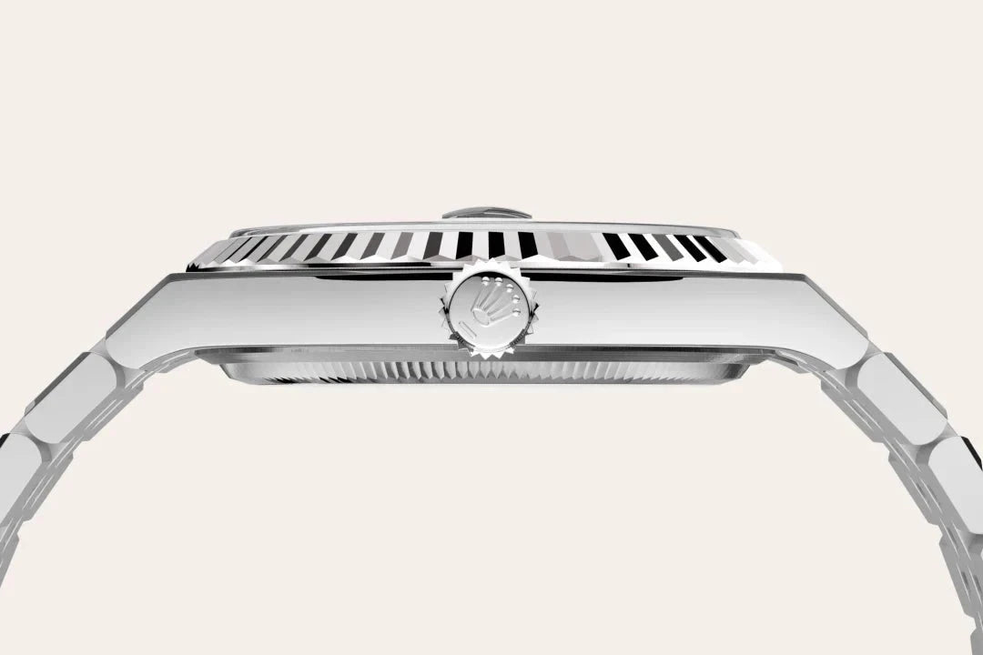 Side profile view of a luxury stainless steel wristwatch with a fluted bezel and a crown featuring the Rolex logo, highlighting its refined craftsmanship and design.