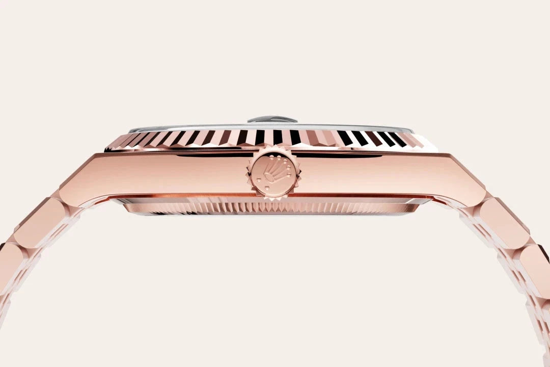 Close-up side view of a rose gold luxury watch with a fluted bezel and crown, highlighting the detailed craftsmanship and elegant design of the timepiece.