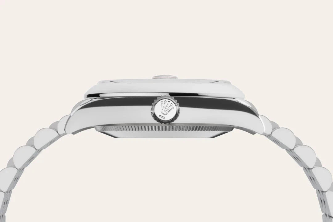 Side profile of a luxury stainless steel Rolex watch highlighting the crown logo and polished bracelet, showcasing refined craftsmanship and timeless design.