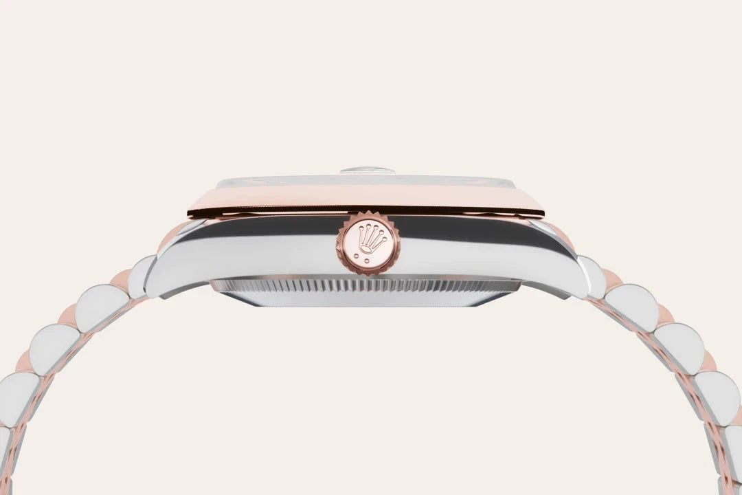 Side view of a luxury Rolex watch showcasing its polished metal case, rose gold bezel, and signature crown on a sleek bracelet, highlighting fine craftsmanship and elegance.