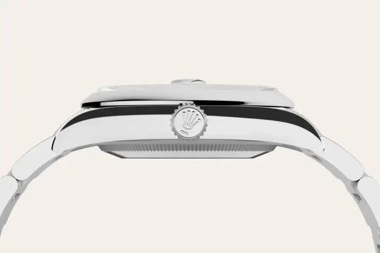 Close-up side view of a polished stainless steel luxury watch case featuring the Rolex crown logo on the winding crown, highlighting fine craftsmanship and design.