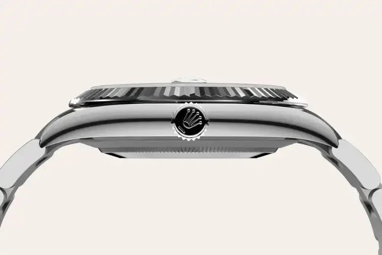 Side view of a polished stainless steel watch case featuring a ridged bezel and a crown with a distinctive embossed logo, highlighting precision craftsmanship and luxury watch design.