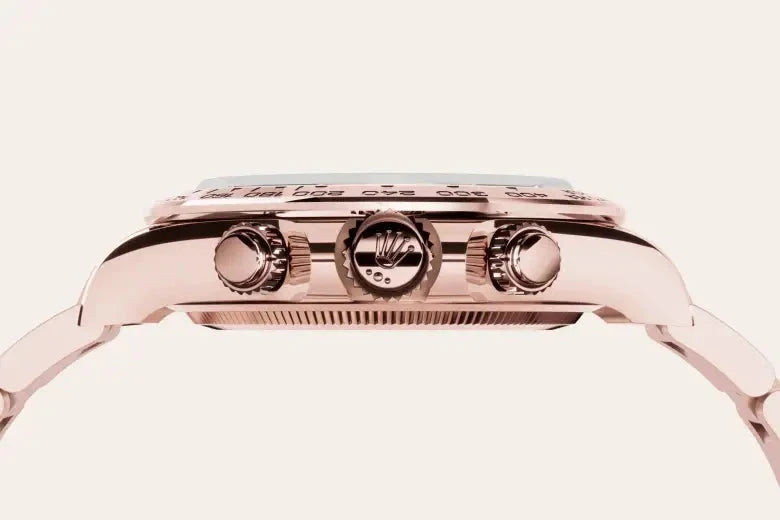 Side view of a luxury rose gold watch featuring a detailed crown and two push buttons, showcasing fine craftsmanship and elegant design typical of high-end timepieces.