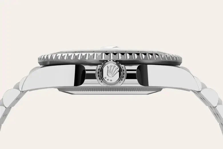 Close-up side view of a luxury stainless steel watch featuring a detailed crown with the Rolex logo, showcasing fine craftsmanship and precision design.