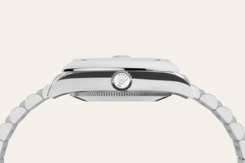 Side profile view of a luxury stainless steel Rolex watch with a polished bracelet and the signature crown logo on the winding crown, highlighting fine craftsmanship.