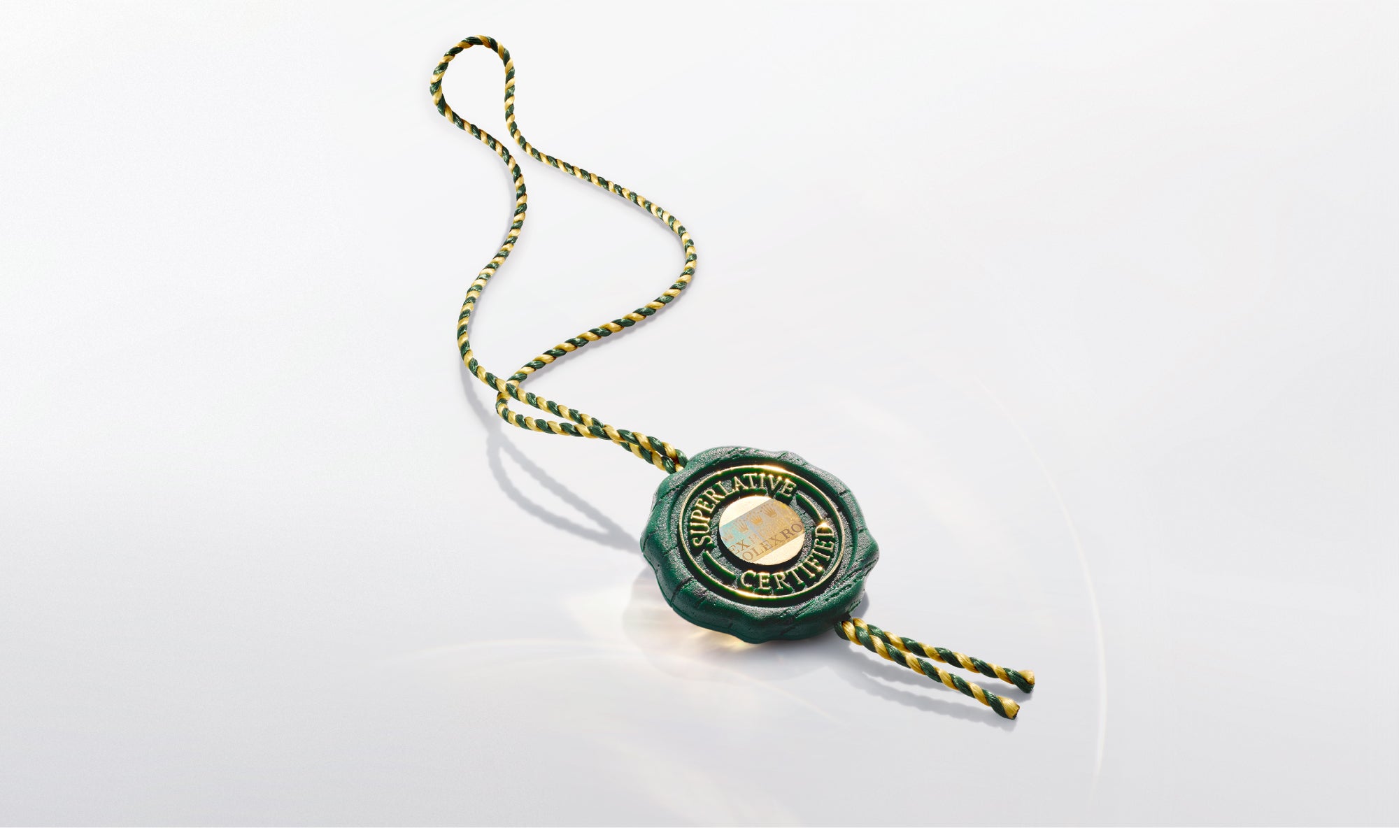 Green and gold Rolex Certified Pre-Owned seal tag with twisted cord on a white background, symbolizing authenticity and luxury jewelry trust.