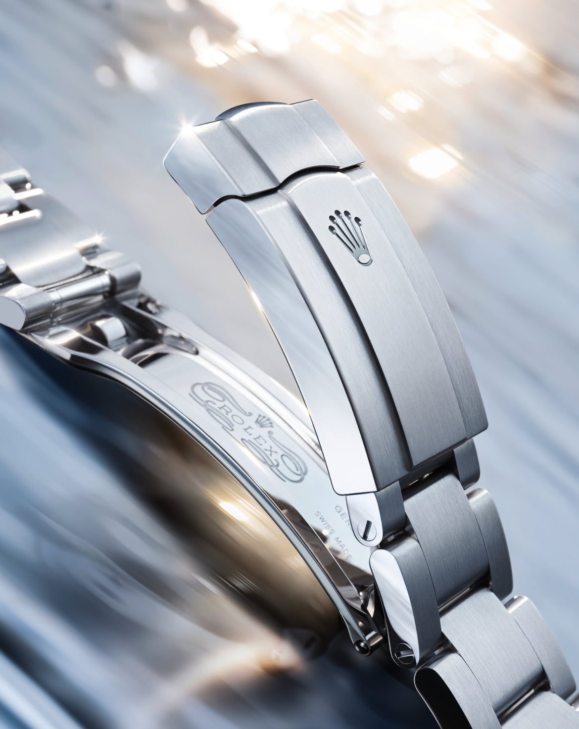 Close-up of a polished stainless steel Rolex watch clasp with the iconic crown logo, highlighting fine craftsmanship, luxury watch design, and elegant metallic finish.