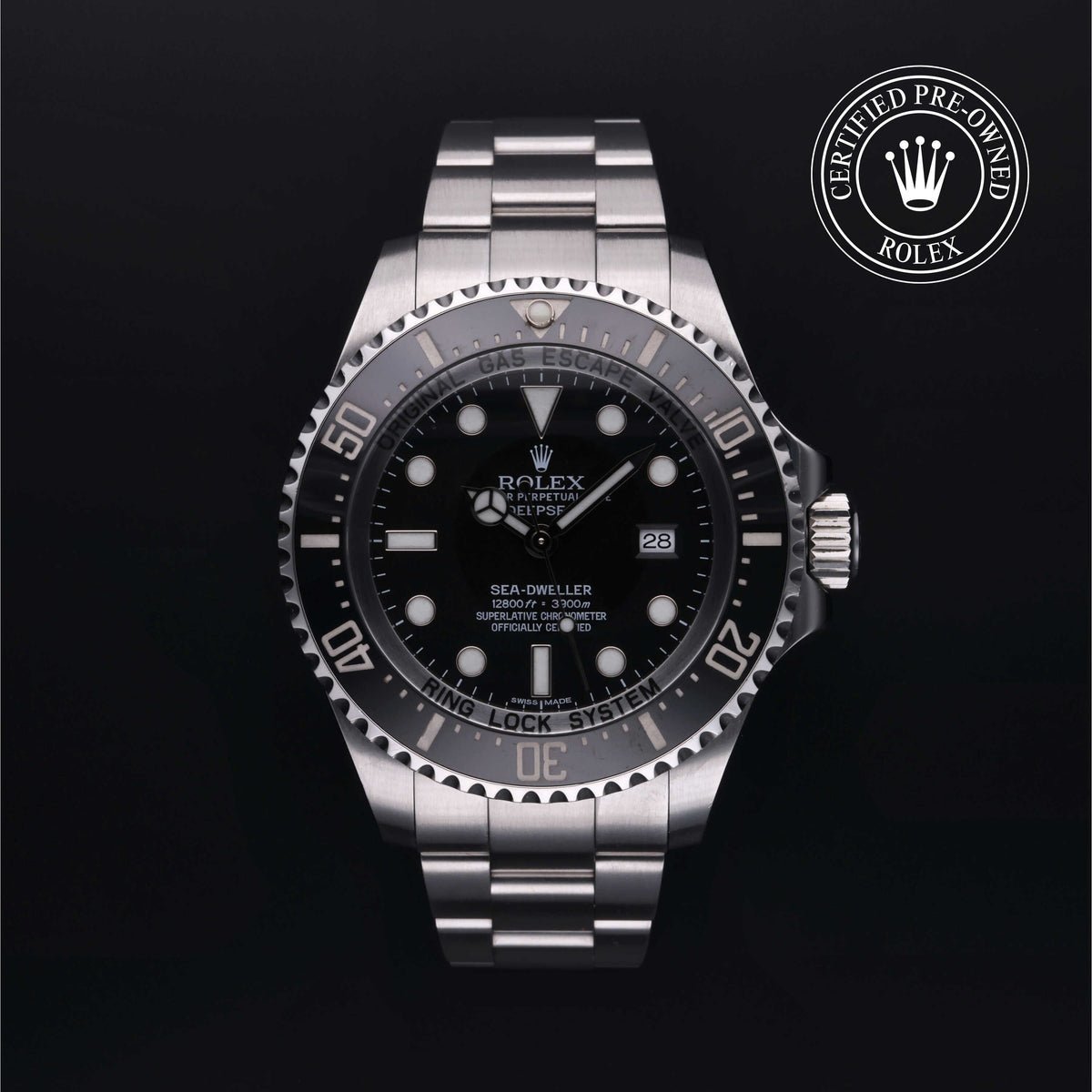 Close-up of a Rolex Sea-Dweller luxury watch with stainless steel bracelet, black dial, rotating bezel, and date display, featuring certified pre-owned Rolex emblem.