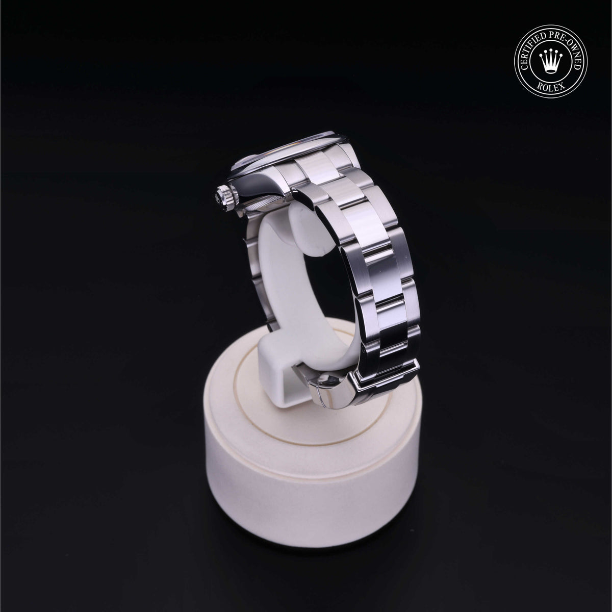 Silver stainless steel Rolex watch band displayed on a white stand against a black background with a Rolex Certified Pre-Owned logo in the corner.