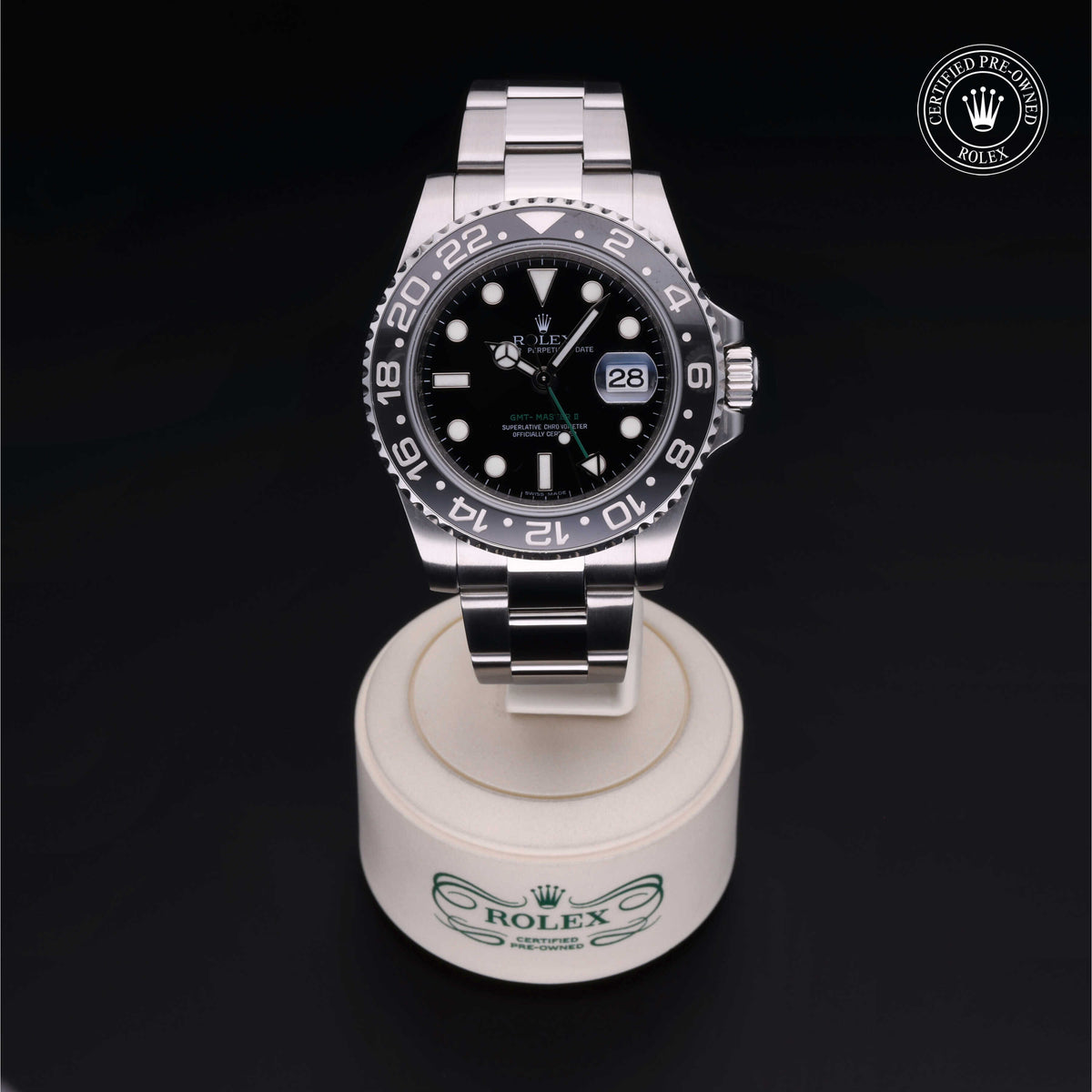 Rolex luxury watch with black dial and stainless steel bracelet displayed on a branded stand with a Certified Pre-Owned Rolex logo, showcasing fine craftsmanship.