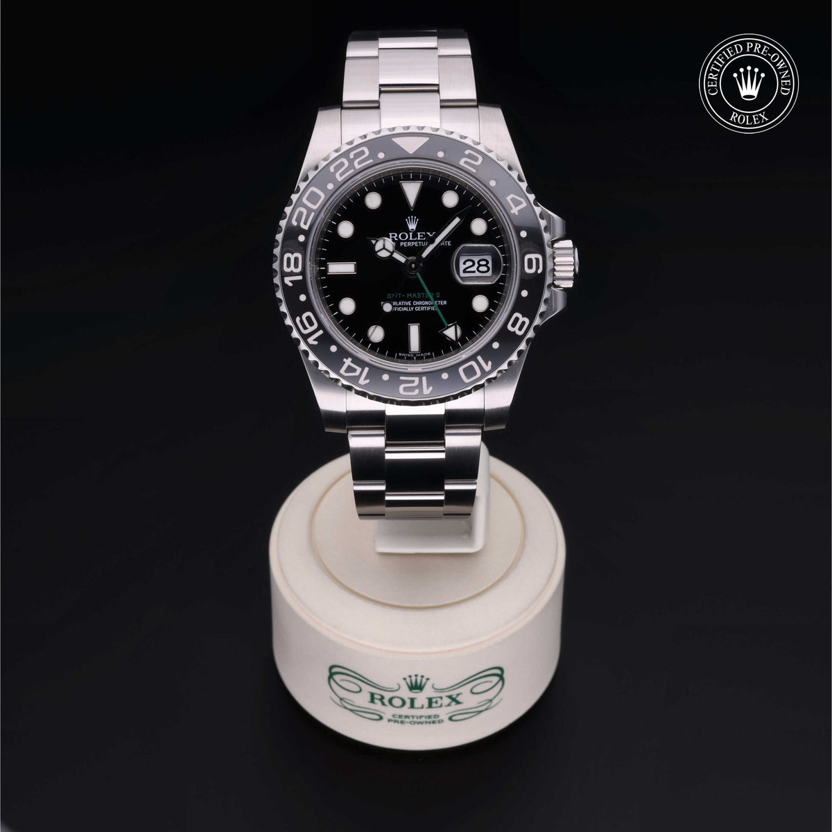 Rolex Certified Pre-Owned stainless steel luxury watch with black dial and date display, presented on a branded Rolex stand against a black background.